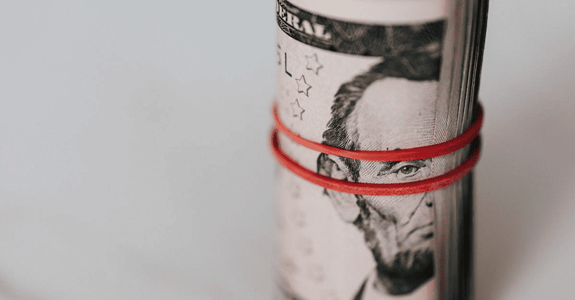 Stack of U.S. Currency Representing Investment Capital | eFinancialModels Rolled stack of U.S. dollar bills, focusing on Lincoln's face