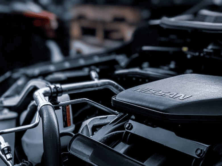 Nissan Engine Close-Up | eFinancialModels Close-up of a Nissan engine showcasing automotive engineering details.