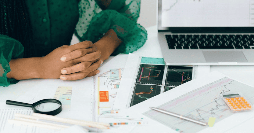 Professional Workspace for Financial Analysis | eFinancialModels Workspace featuring financial charts, a laptop, and analysis tools.